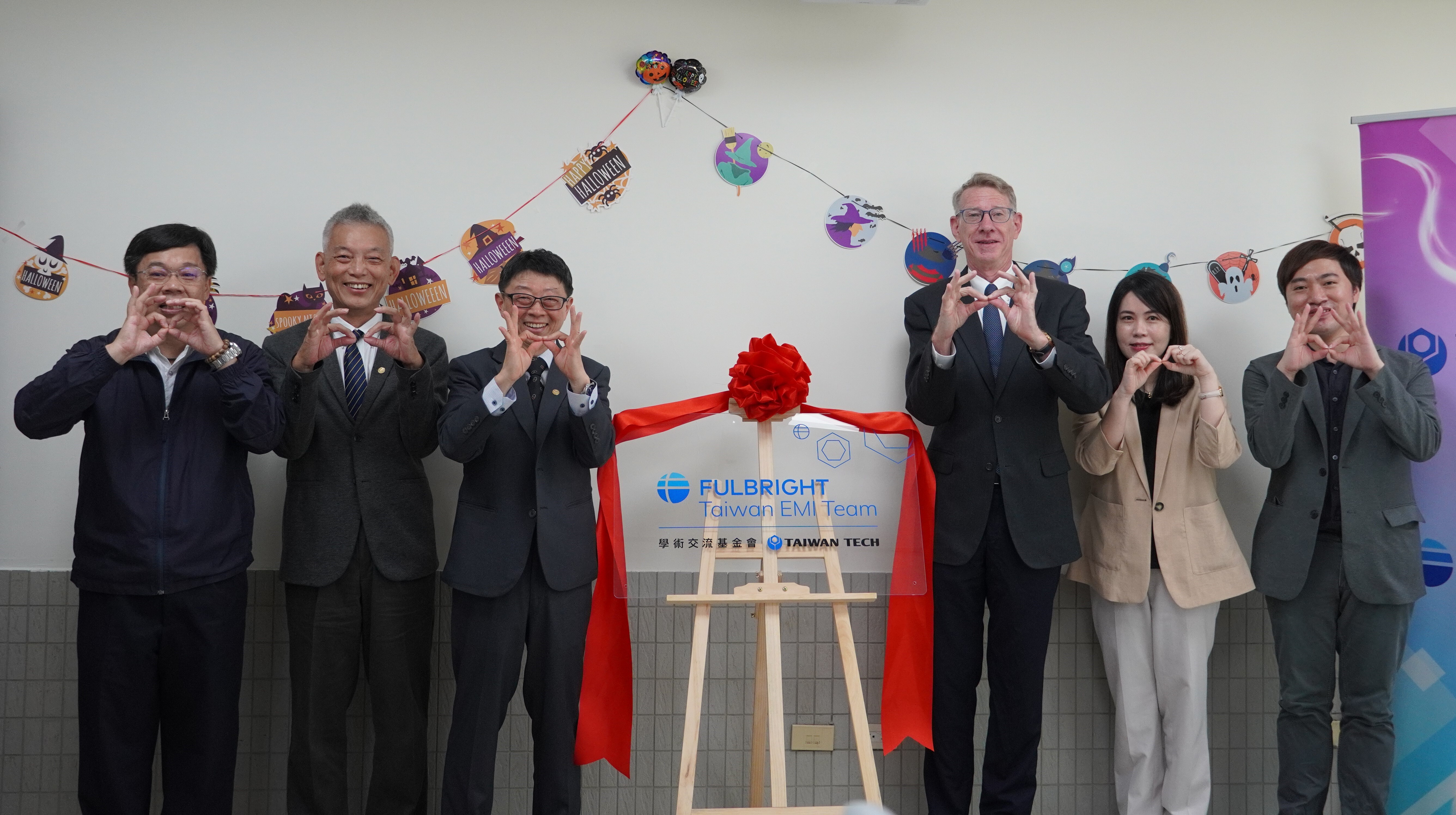 During the Taipei Tech EMI Teaching Support Team Office unveiling ceremony, the participating guests formed the infinite symbol, symbolizing the collaborative journey of Taipei Tech and the Academic Exchange Fund towards infinite possibilities, co-creating new values in vocational education. From right to left, the distinguished attendees included Dr. Zhi-Kai Yang, Advisor to the Academic Exchange Fund; Ms. Chun-Yi Chang, Director of the Academic Exchange Fund's English Teaching Program; Dr. Nai-Yuan Na, CEO of the Academic Exchange Fund; President Jia-Yush Yen; Vice President Chih-Chen Liu; and Dean Chin-Hwa Ho of the College of Applied Sciences.