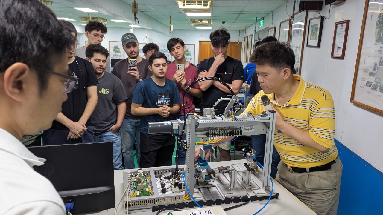 Professor Zhi-Hui Li demonstrates the operation of a Programmable Logic Controller (PLC).