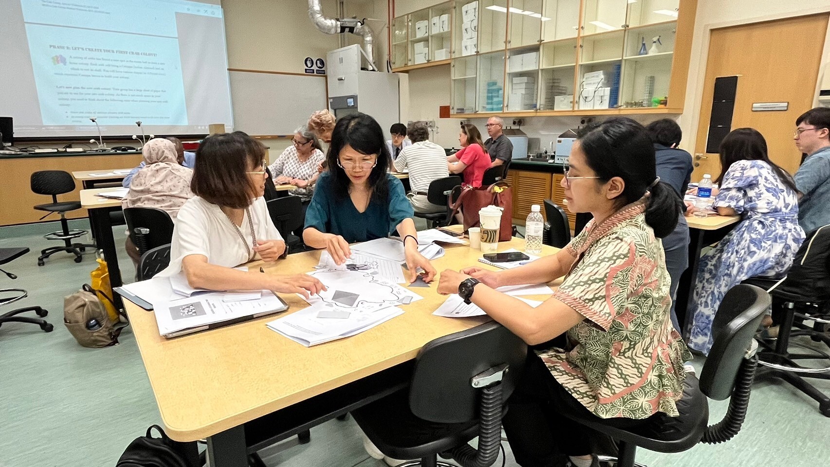 Taiwan Tech faculty members engaged in group practical exercises at the International STEM Education Workshop. 